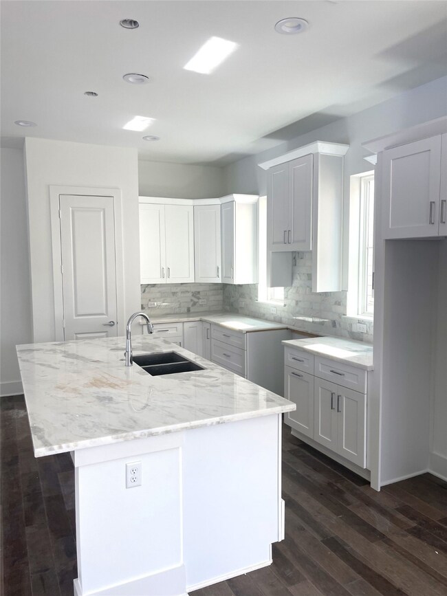 Marble Island with Deep Sink and Cabinets.