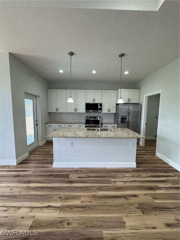 Kitchen with fridge, stainless steel range with el