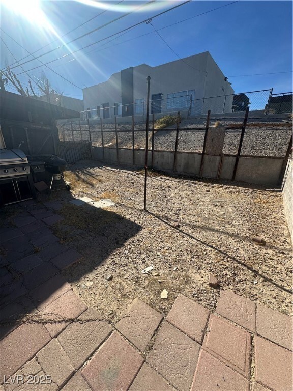 View of yard featuring fence