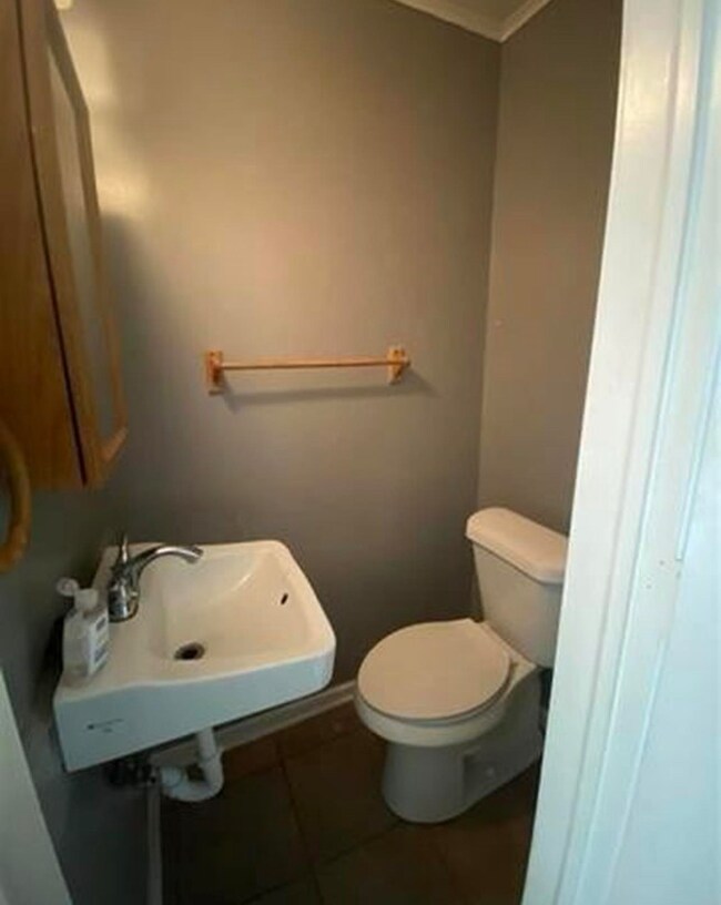 Bathroom featuring tile patterned floors, crown mo