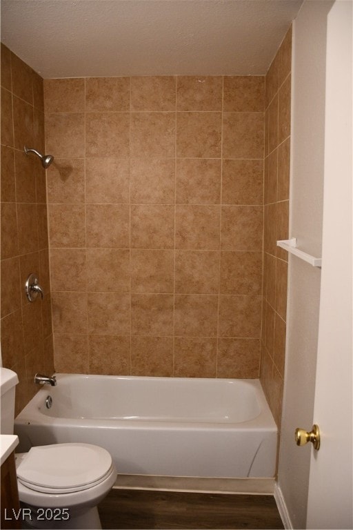 Bathroom featuring shower / bath combination, vanity, and wood finished floors