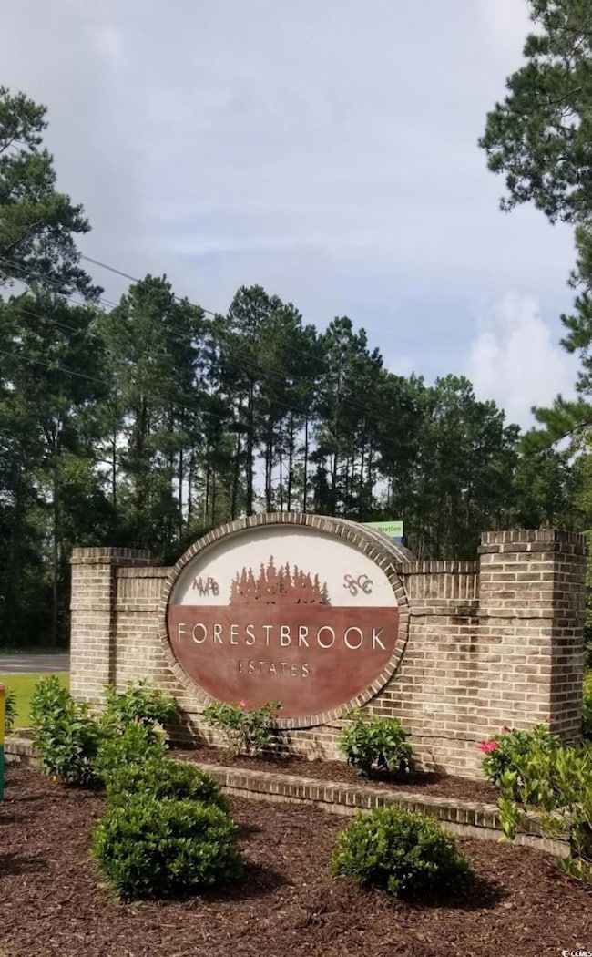 Community sign featuring view of scattered trees