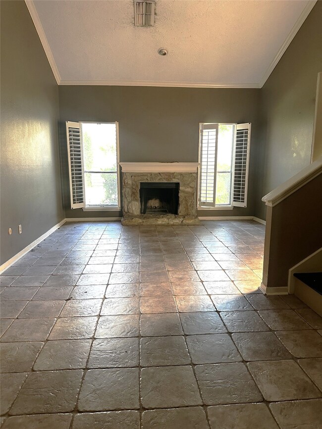 Spacious living room with high ceilings and firepl