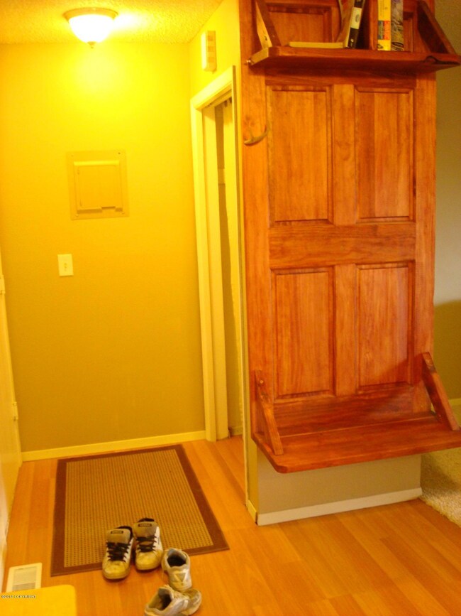 entry closet with custom shelf/bench.