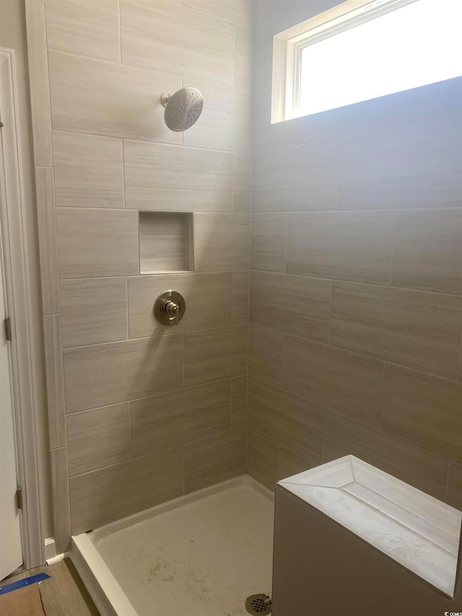 Full bathroom featuring tiled shower