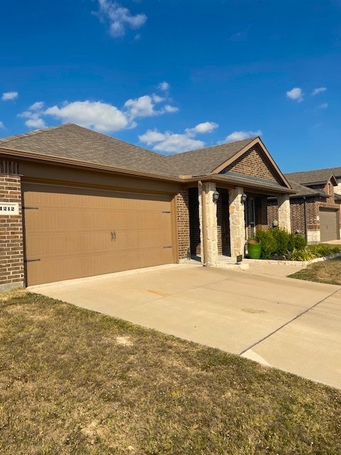 Ranch-style home featuring brick siding, concrete driveway, a shingled roof, and a garage