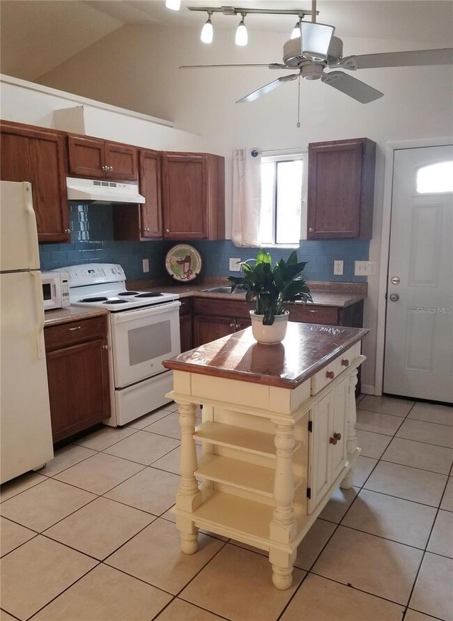 Pleasant natural light and open feel, with ceiling fan to keep the cook comfortable