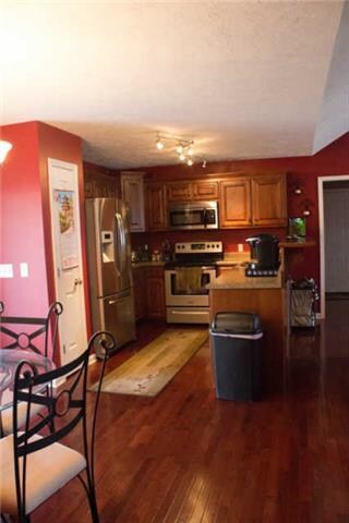 Kitchen with cherry cabinets and hardwood floors