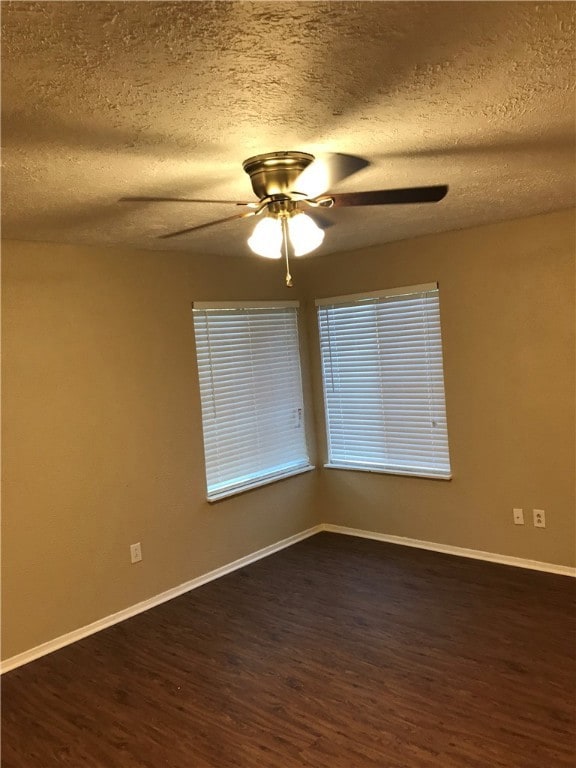 Unfurnished room featuring a textured ceiling, dar