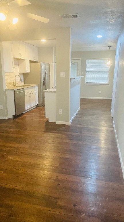 Kitchen with stainless steel dishwasher, dark wood