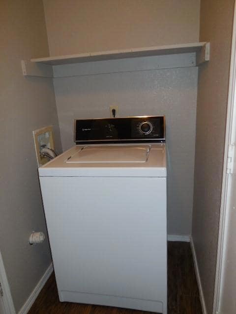 Clothes washing area featuring washer / dryer, dar
