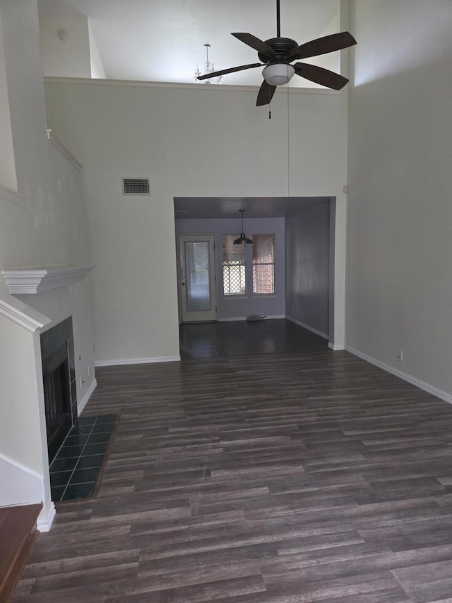 Unfurnished living room featuring a high ceiling,