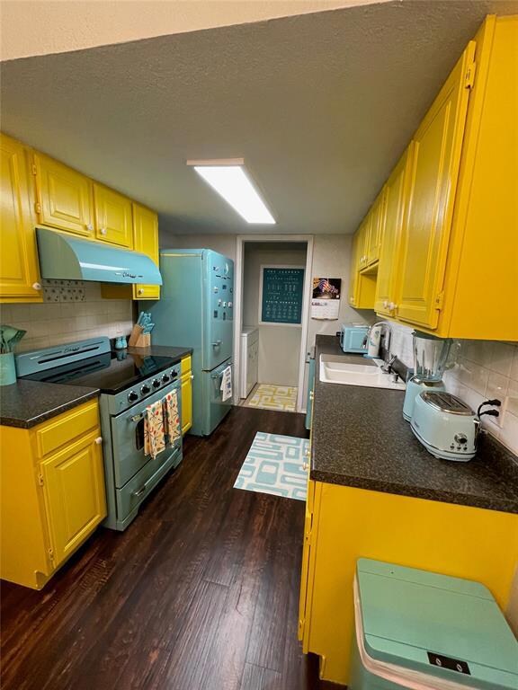 Kitchen with dark hardwood / wood-style floors, st
