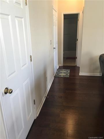 standing in the kitchen, beside the living room, t