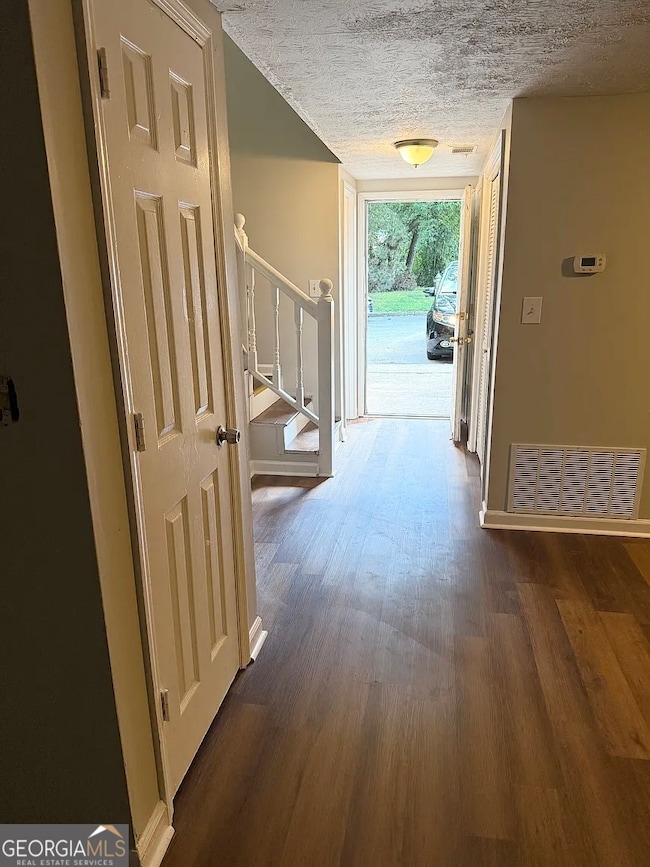 View from the front door with attractive wood-look flooring throughout and open flow toward the main living area.