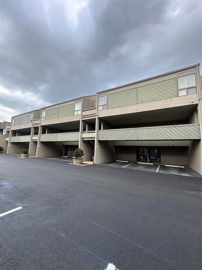 View of building exterior featuring covered parking