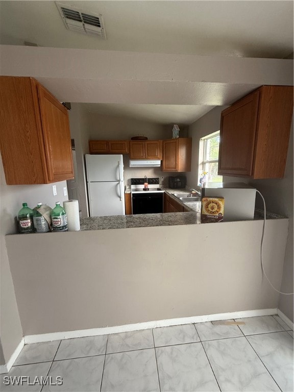 Kitchen with fridge, white range with electric sto