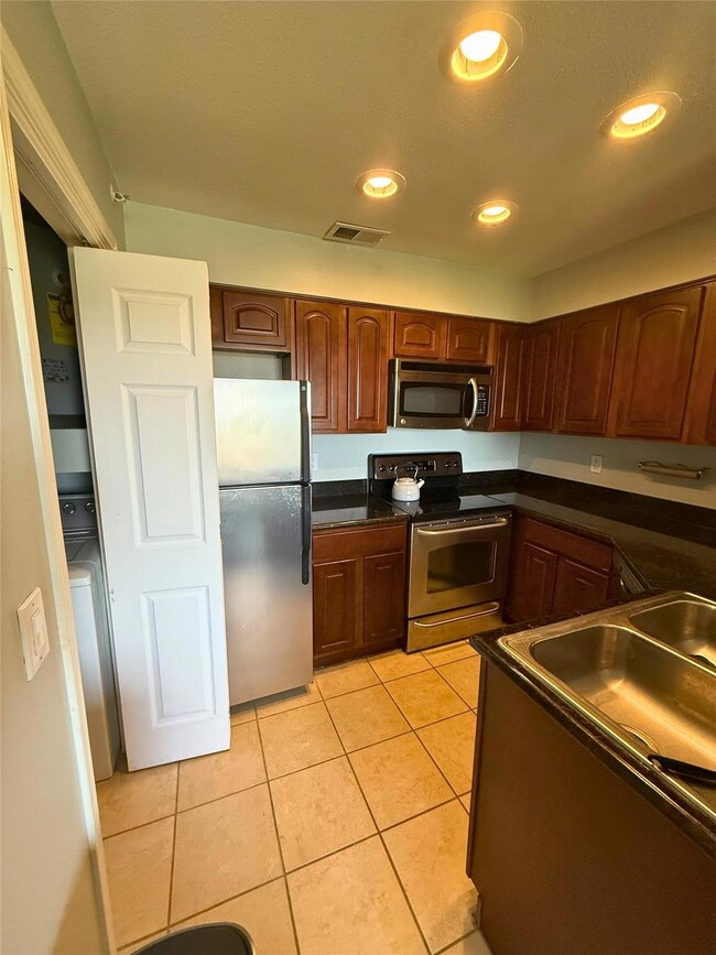 Kitchen featuring stainless steel appliances, dar
