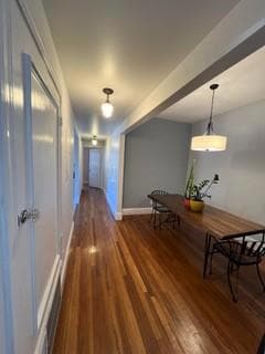 Hall with dark hardwood / wood-style floors