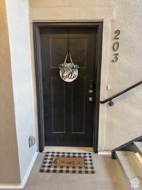 Property entrance with stucco siding