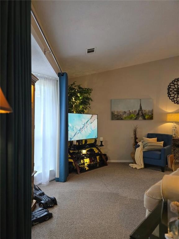 Living area with carpet and baseboards