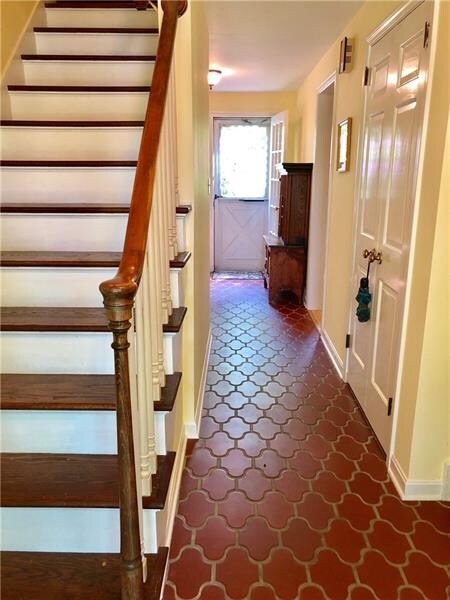Wide, tiled entry welcomes you via front or back d