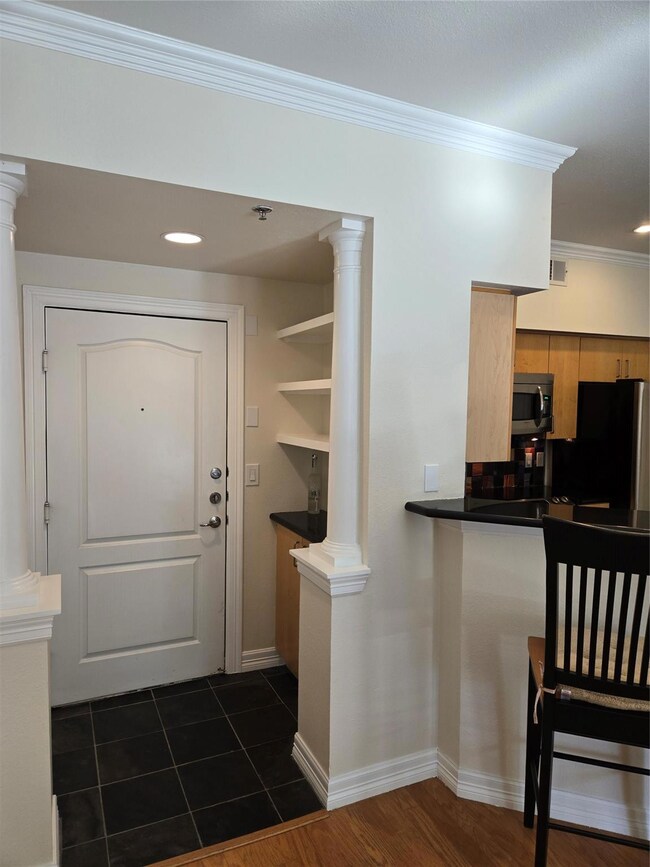 Entrance to #304 with shelving in the foyer.