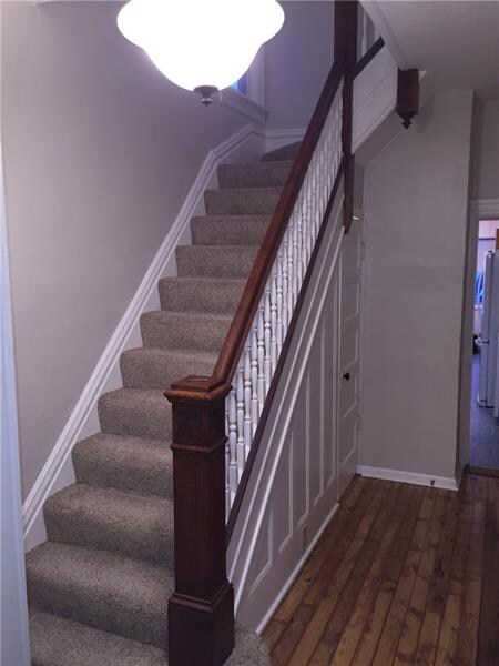Main Foyer: pine hardwood floors and original bani