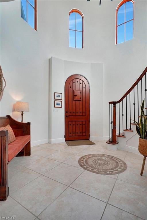 Entrance foyer with light tile patterned floors an