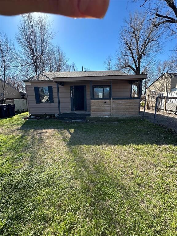 Rear view of property with a lawn