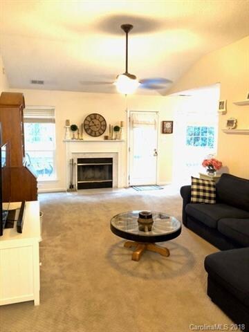 Great room has a vaulted ceiling with ceiling fan 