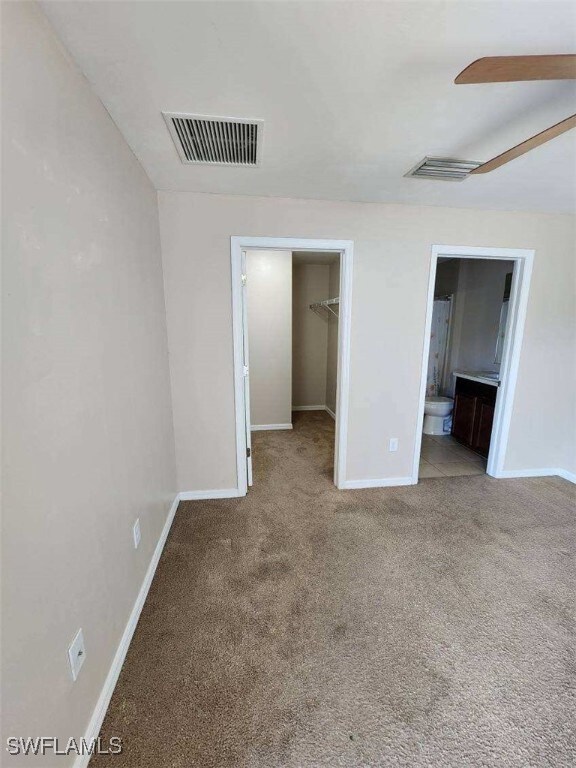 Unfurnished bedroom featuring carpet flooring, bas
