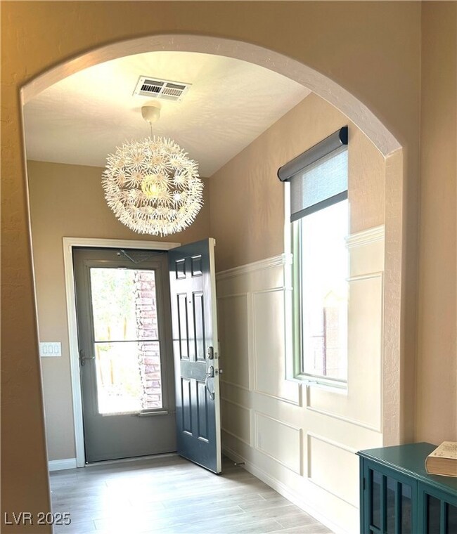 Foyer entrance featuring a decorative wall, plenty