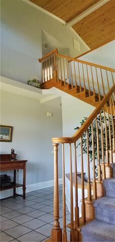 Elegant Entry with lovely Staircase and Wood Ceili