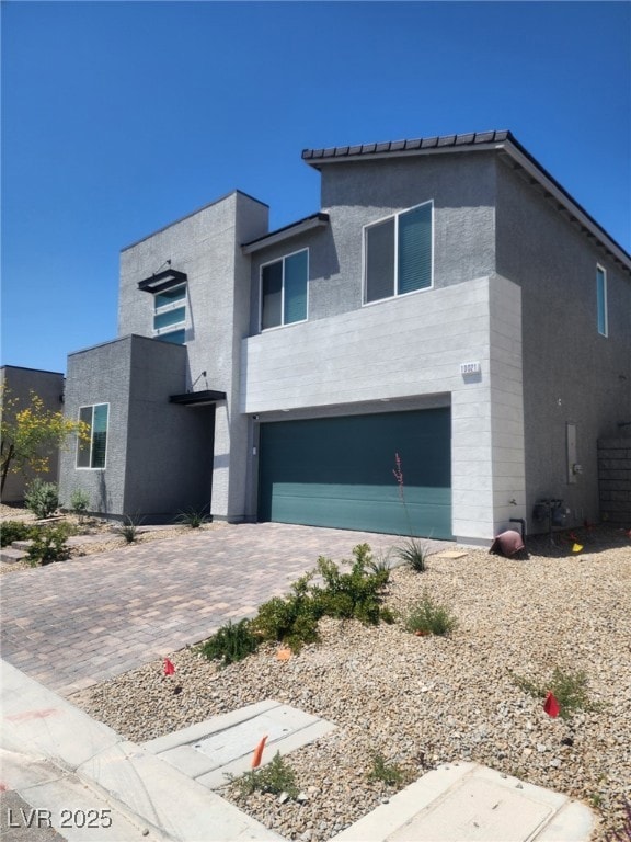 Contemporary home featuring a garage, driveway, an