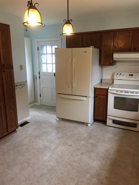 Dutch door to left of refrigerator.