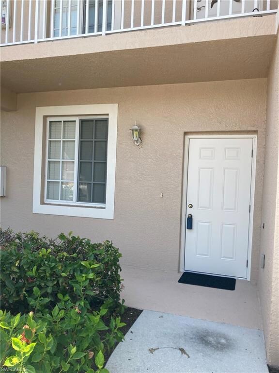 Property entrance featuring stucco siding