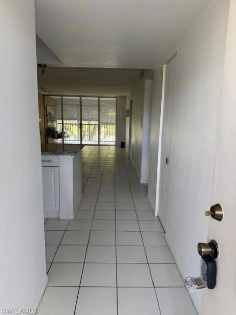 Corridor featuring light tile patterned flooring