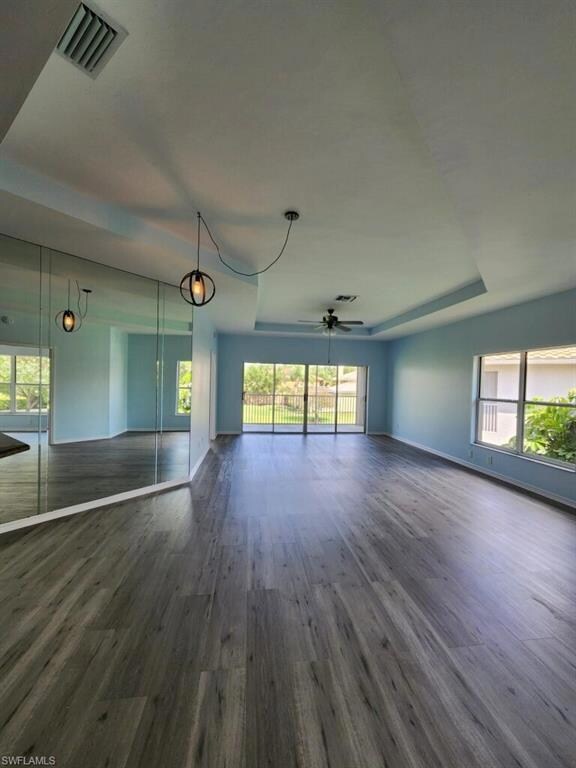 Unfurnished living room featuring baseboards, visi