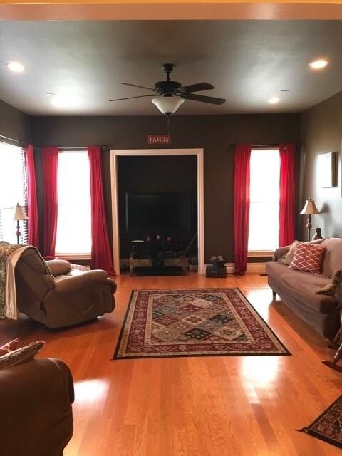The family room just off the kitchen. Note the wood flooring and lots of windows.