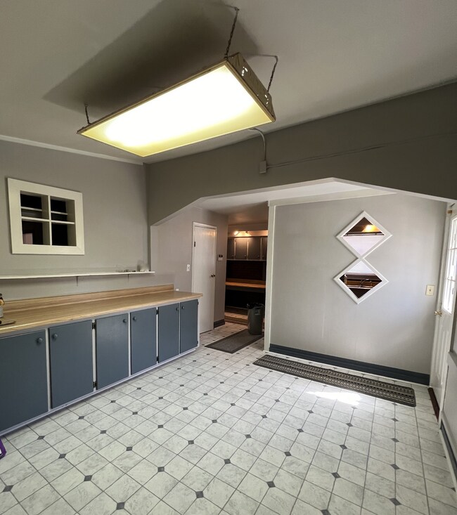 Additional view of the dining room, large pantry with built in shelves and pass through door to the full kitchen
