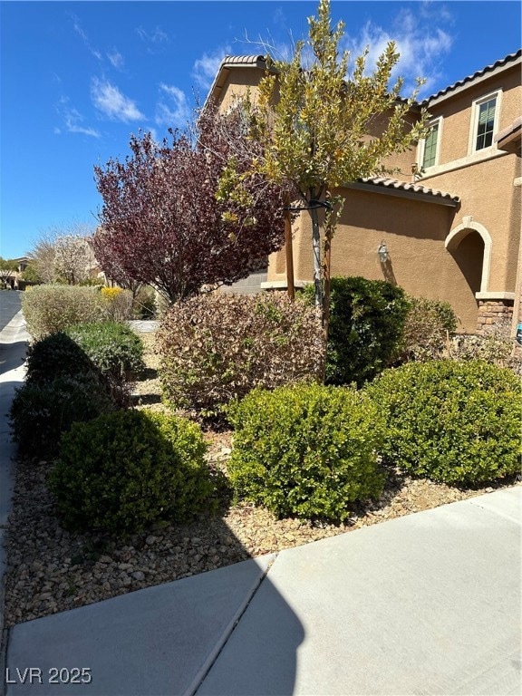 View of side of property featuring stucco siding a