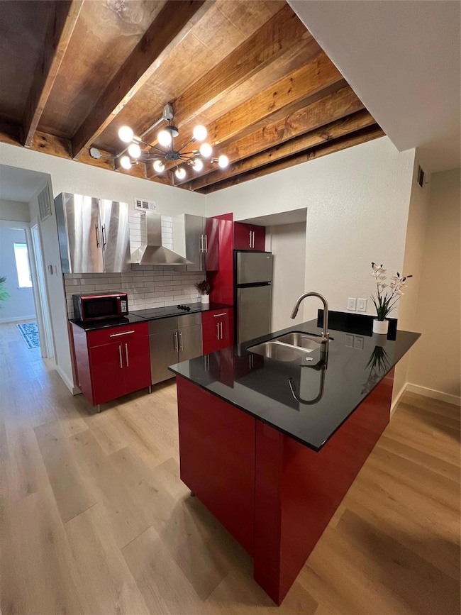 Kitchen with refrigerator, light hardwood / wood-s