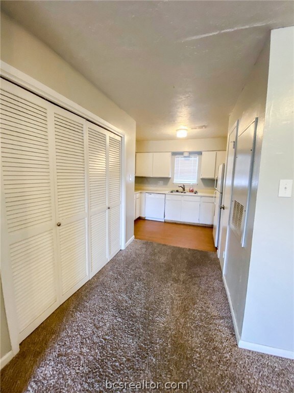 Laundry area to the left behind doors and pantry t