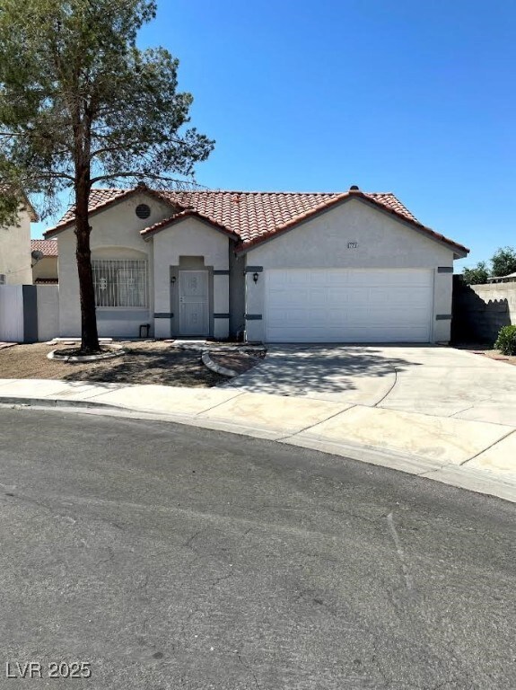 Mediterranean / spanish house featuring a tile roo