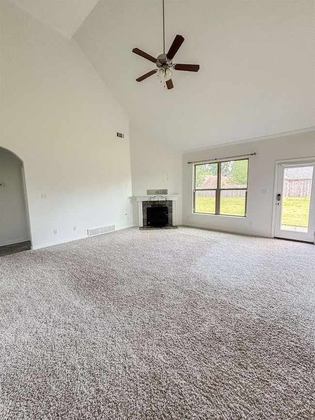 Unfurnished living room featuring high vaulted cei