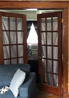 Orginal wood. French doors into first bedroom.