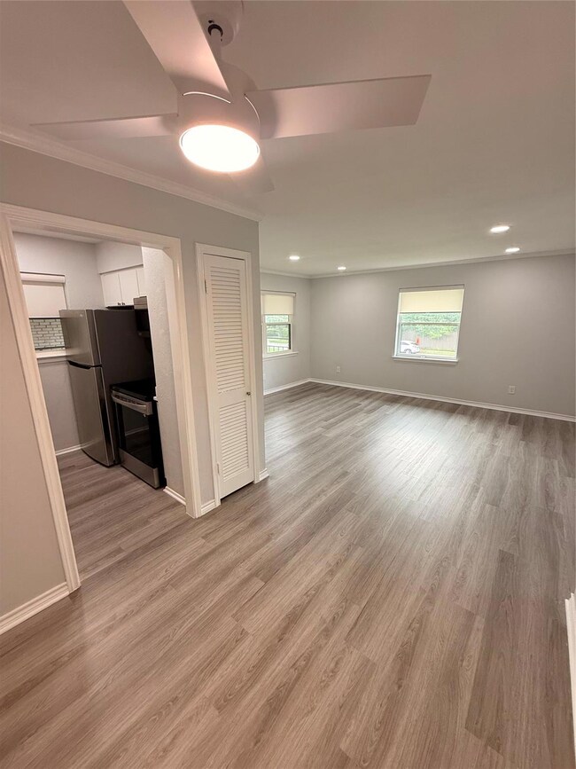 wood finished floors, ceiling fan, and baseboards