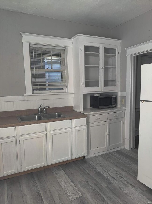 Eat in kitchen, new flooring, updated sink, access back yard or to  basement