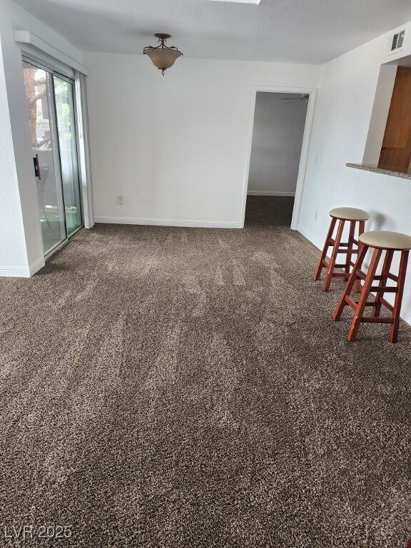 Carpeted spare room with baseboards